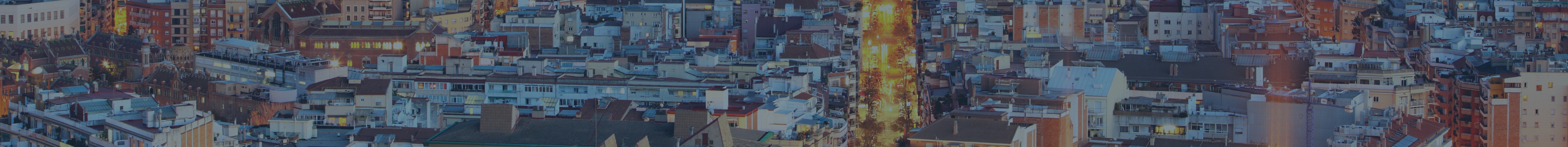 An aerial view of a city at night providing legal advice for property buying in Spain.