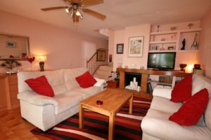 A semi detached Villa near Alicante featuring a living room with a tv and a fireplace.