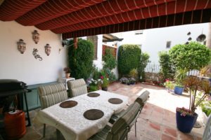 A semi detached villa near Alicante with a patio featuring a table and chairs.