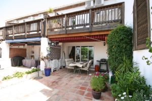 A semi detached villa near Alicante with a patio area featuring a table and chairs.