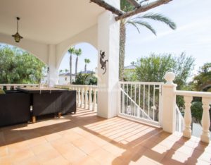 A semi-detached Villa near Alicante with a balcony overlooking a palm tree.