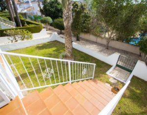 A view of a semi-detached villa with stairs leading to a garden near Alicante.