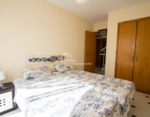 A bedroom in a semi detached Villa near Alicante with a bed and a dresser.