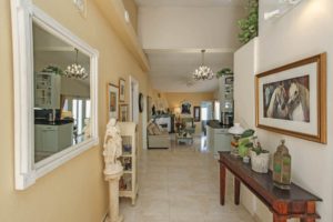 A Detached villa near Alhaurín el Grande on the market with a hallway featuring a table and a mirror.