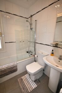 A semi-detached villa near Alicante with a bathroom featuring a toilet, shower, and sink.