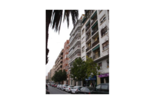 A street with many buildings and cars parked in front of them, located in the centre of Valencia with prices below 1000€/m2.