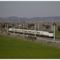 A fast train from Spain traveling down a track in a field after 25 years.