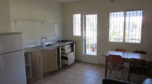 A small kitchen with a refrigerator and a table in a 7-bedroom (B&B) villa with 6 en-suite bathrooms in Lliber - Jalon Valley.