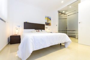 A white bed in a bedroom of a villa for sale in Villamartín - Orihuela Costa.