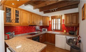 Detached Villa with red tile kitchen and wooden cabinets for sale in Coín.