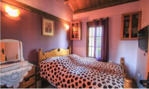 Detached Villa for sale in Coín with a bedroom featuring purple walls and a zebra print bed.