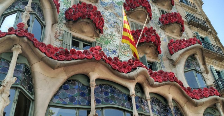 The Unesco World Heritage site in Spain is surrounded by a vibrant display of red flowers.