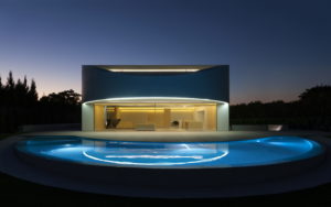 A modern house with a swimming pool at night, your architect design dream house.