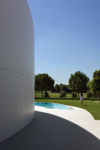 A circular-shaped, white dream house in Spain with a pool.