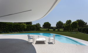 A white table and chairs complement the architect-designed swimming pool in your dream house in Spain.
