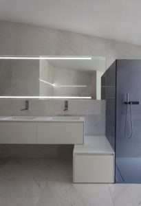 A modern bathroom with a glass shower and sink in your dream house designed by an architect in Spain.