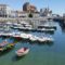 Boats docked in a harbor near a city with Spanish property transactions.