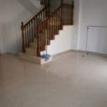 A vacant terraced house in Tenerife featuring an empty room with stairs and a railing.
