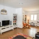Detached 4 bedrooms Villa for sale in Tolox with a living room featuring a fireplace and bookshelves.