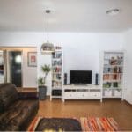 A detached 4 bedrooms villa for sale in Tolox with a living room featuring a TV and bookshelves.