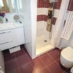 Detached 4-bedroom villa for sale in Tolox, featuring a bathroom with a toilet, sink, and shower.
