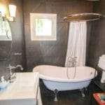 A detached 4-bedroom villa for sale in Tolox with a bathroom featuring a bathtub and a sink.