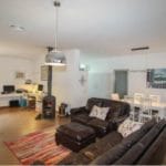 Detached 4 bedrooms Villa for sale in Tolox with a living room furnished with brown leather furniture and a wooden floor.