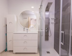 A luxurious apartment in La Zenia, Costa Blanca South, featuring a white bathroom with a shower and sink (2015).