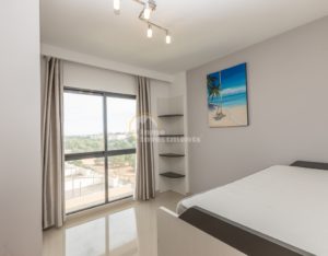 A luxury apartment in La Zenia with a bed and a view of the ocean, located in Costa Blanca South.