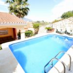 A detached villa in Mijas Costa with a swimming pool.