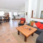 Detached Villa Mijas Costa featuring a living room with couches and a dining table.