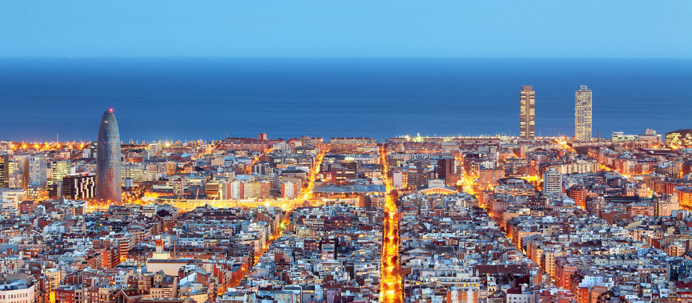 The city of barcelona at dusk.