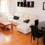 A Villamartin townhouse in Orihuela Costa with a living room and dining table.