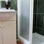 A small bathroom with a sink and shower in a townhouse in Villamartin for less than 100.000€ on Orihuela Costa.