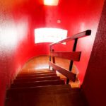 A townhouse in Villamartin with a staircase leading to a room with red walls.