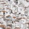 An aerial view of a picturesque town in Spain with properties available for sale.