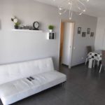 Beautiful 3 bedroom apartment in Los Cristianos with a white couch and dining table.
