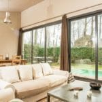 Detached Villa in Girona with sliding glass doors and a pool.
