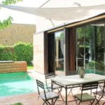 A detached villa in Girona with a pool and outdoor seating area.
