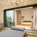 Detached stone villa with a patio and a bed in Girona - Torroella de Fluvià.