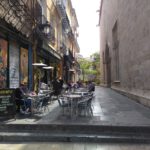 A bustling sidewalk cafe in Valencia's real estate market.