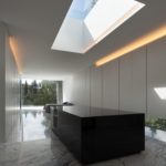 A modern kitchen with a skylight above it.