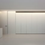 A white closet in a room with white walls.