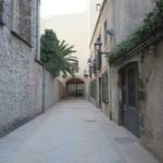 A narrow alleyway in Barcelona with potential for real estate development.
