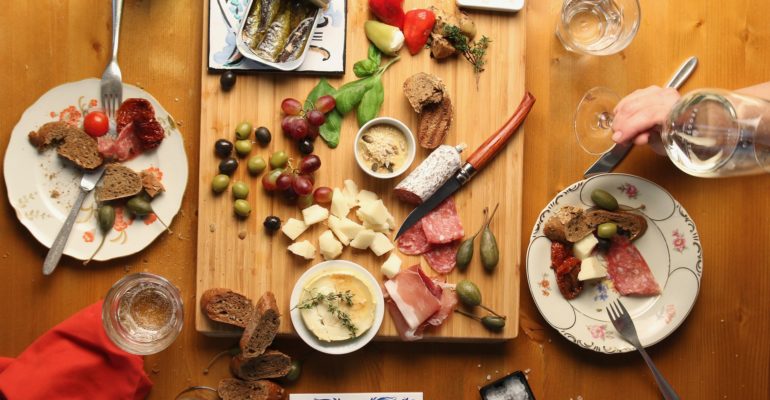 A table full of Spanish food on a wooden cutting board.
