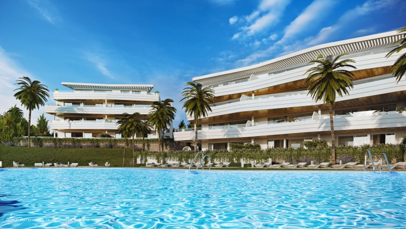 A new build apartment complex with a swimming pool and palm trees in Higueron West, Malaga.