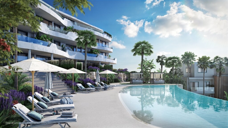 A new build apartment complex in Higueron West featuring a swimming pool and lounge chairs.