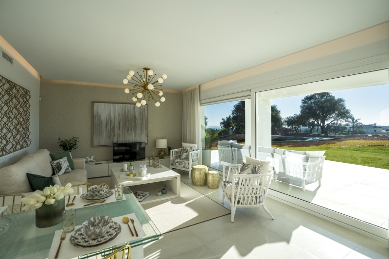A San Roque new build apartment with a glass sliding door and a view of the golf course.