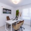 A new build San Roque penthouse with a white office including a desk and chairs.