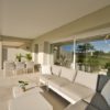 A San Roque penthouse with white furniture and a view of the golf course.